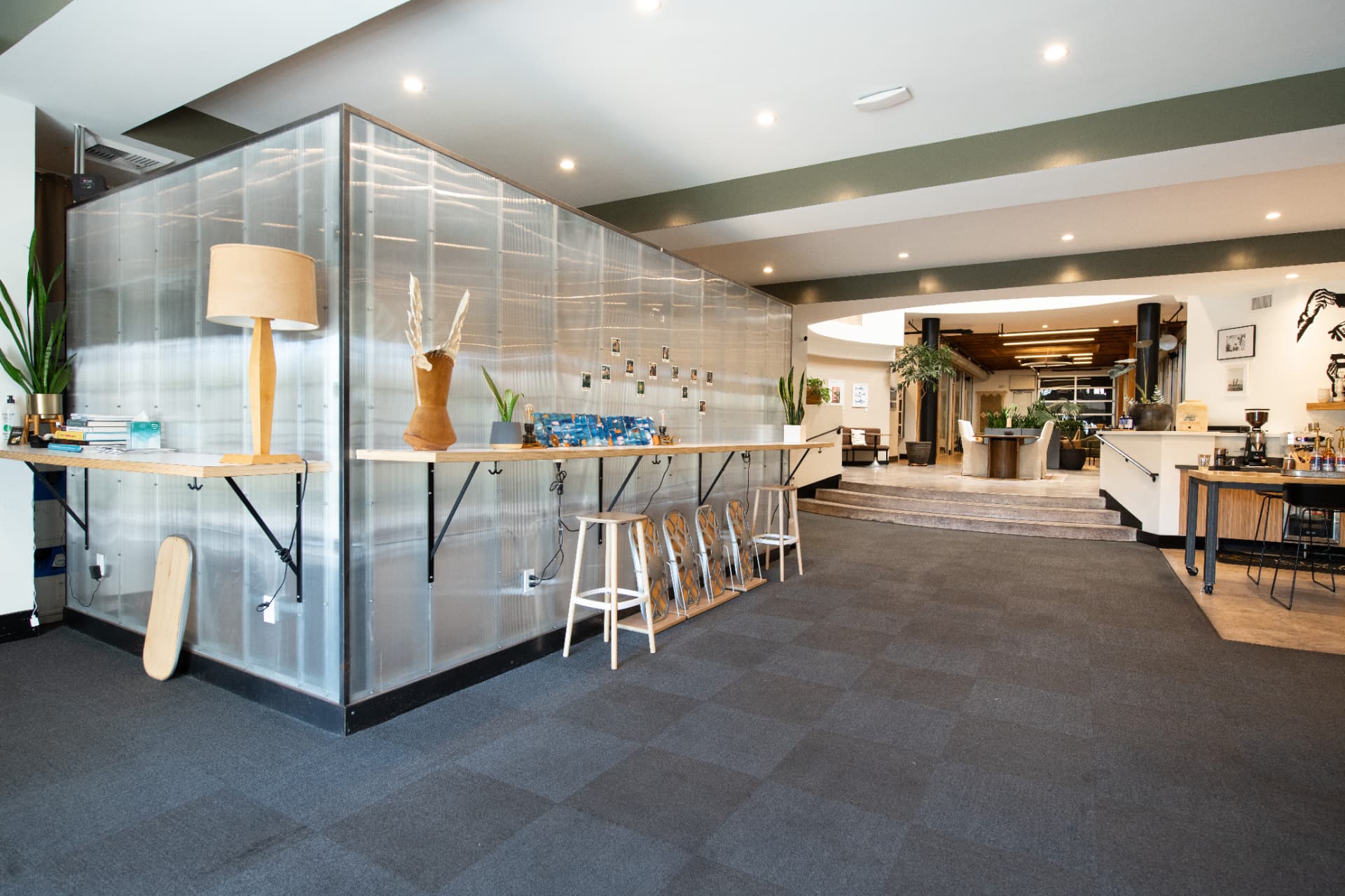 Reception area at Kiva State St. with counter seating and a corrugated glass partition