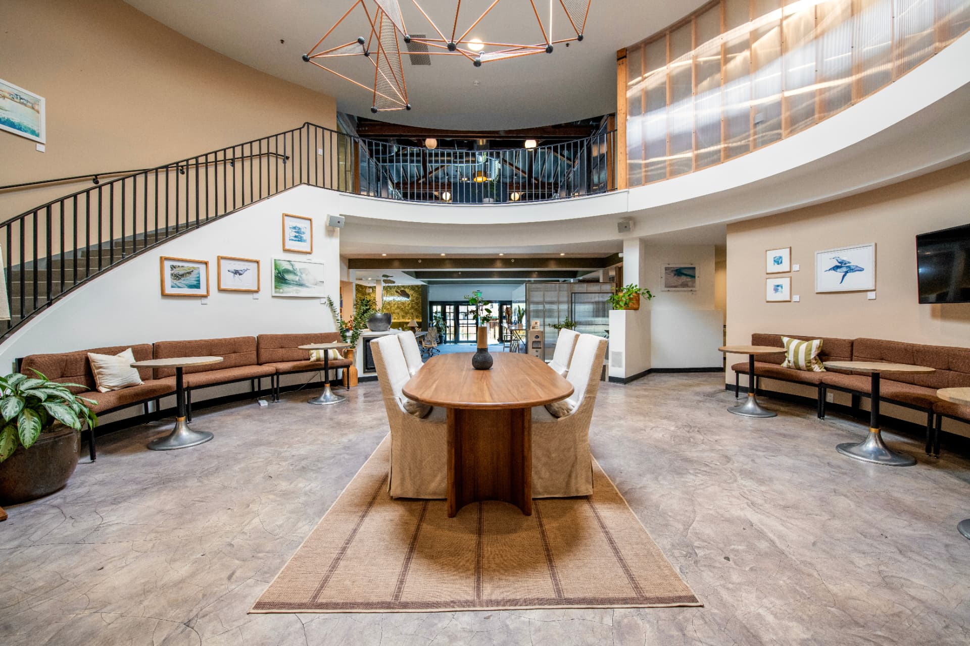 Kiva Cowork's State Street atrium with lounge seating and a communal table